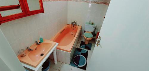 a bathroom with a tub and a toilet and a sink at Calamari 11 - 6 Sleeper - 30 Steps From The Beach! in Margate