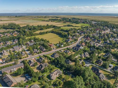 an aerial view of a village with houses and trees at Ferienwohnung Dünenblick in Sankt Peter-Ording