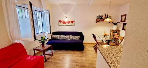 a living room with a couch and a table at Les Flors !2minutos de la playa! in Lloret de Mar