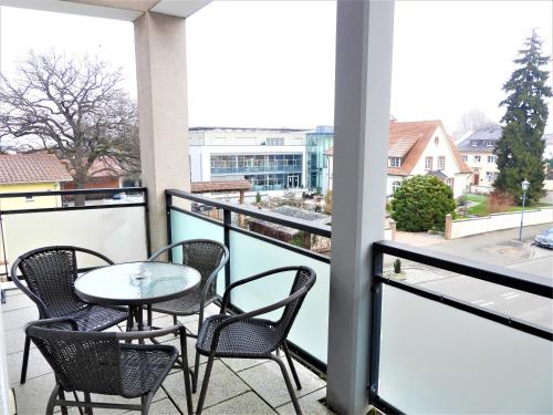 a balcony with a table and chairs and a view at Braviscasa - Ferienresidenz Stadttor Endingen in Endingen
