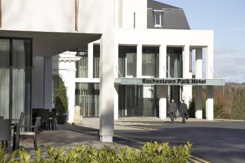 a white building with people walking in front of it at Rochestown Park Hotel in Cork