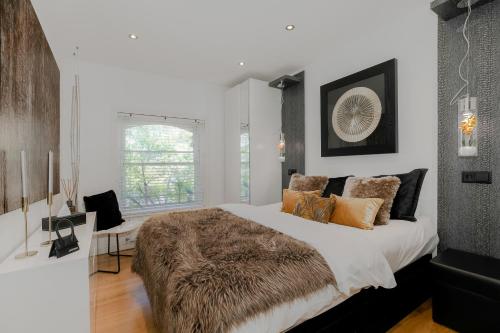 a bedroom with a large bed with a brown blanket at Cool Covent Garden Theatre Design Hub for Families Friends Couples in London