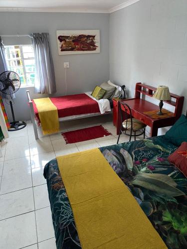 a living room with two beds and a table at Bedford Way cottages in Bedford