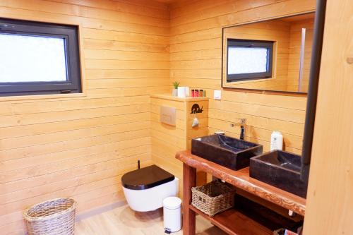 a bathroom with two sinks and a mirror at MAS DE REY Uzès in Arpaillargues-et-Aureillac