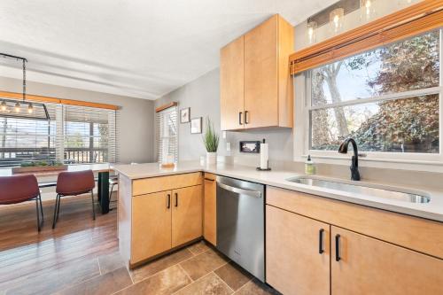 a kitchen with wooden cabinets and a sink at Lakeshore Living in Lake Junaluska