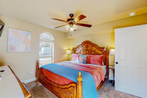 a bedroom with a bed and a ceiling fan at Urban Deck House in Eureka Springs