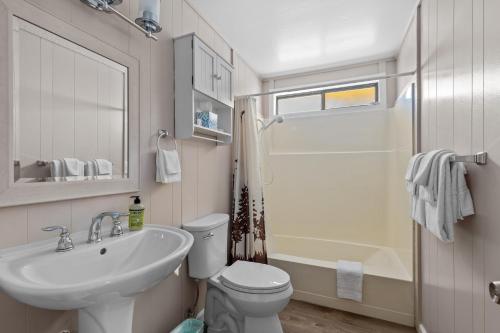 a bathroom with a sink and a toilet and a tub at Big Trees, Little Cabin in Arnold