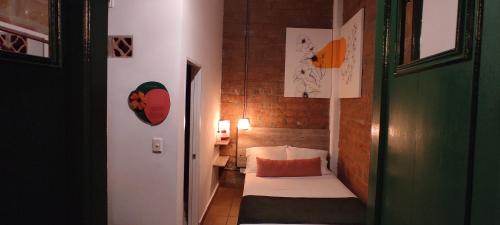 a small bedroom with a small bed in a room at Botánica Casa Hotel in Medellín
