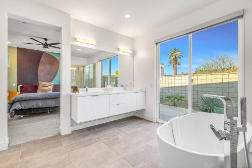 a bathroom with a tub and a bedroom with a bed at Artfully Indian Wells in Indian Wells