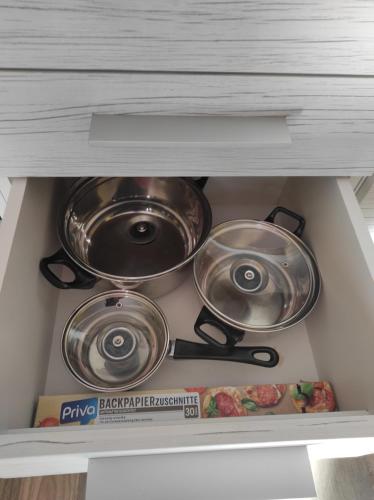 three pots and pans in a drawer in a kitchen at Haus Kraus in Bayerisch Eisenstein