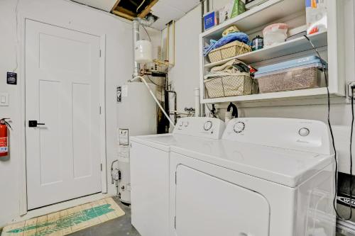 a laundry room with a white washer and dryer at Pinellas Retreat in Pinellas Park