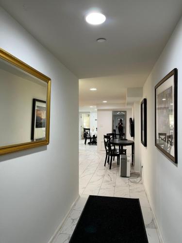 a living room with a table and a mirror at Lovely Remodeled 2bdrm Basement Home in Washington, D.C.