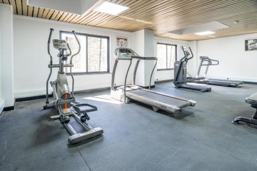 a gym with three tread machines in a room at Sarova Imperial Hotel in Kisumu