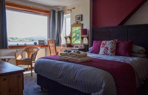 a bedroom with a bed with towels on it at Tarradale Cottage in Portree