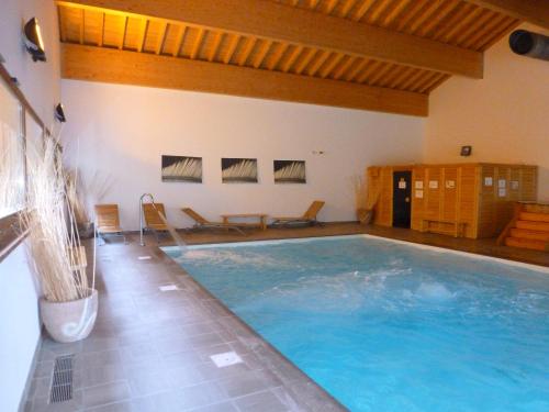 a large indoor swimming pool in a house at Orelle Val Thorens Appartement 2 pieces 5 personnes aux portes du Parc de la Vanoise in Orelle