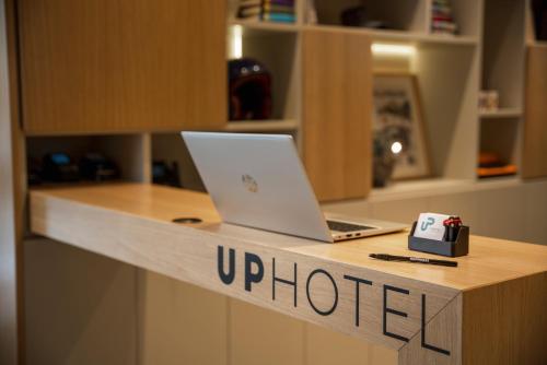 a laptop computer sitting on top of a counter at Up Hotel in Rimini