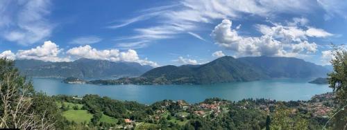 a view of a large body of water with mountains at Casa Intignano - Camera con bagno e portico vista lago in Tremezzo