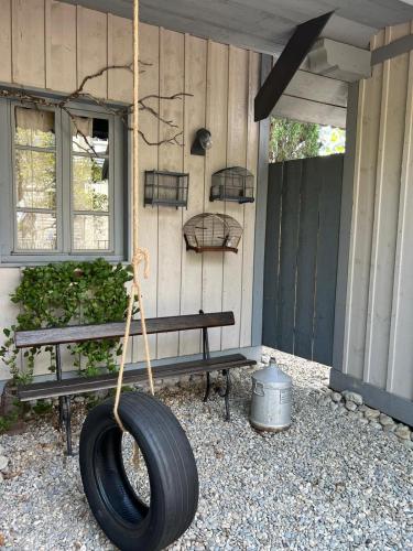 a tire swing hanging from the side of a house at Les chambres de Pauline avec spa et climatisation parking moto garage vélo in Albertville