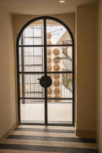 an entrance to a room with a large window at room Select Tetuán in Seville