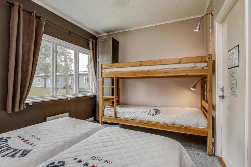 a bedroom with two bunk beds and a window at STF Hostel Lärbro/Grannen in Lärbro
