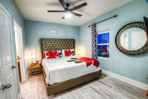a bedroom with a bed with red bows on it at Laketown Wharf Resort 416 By Aneliya in Panama City Beach