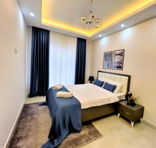 a bedroom with a large bed and a window at Flat with Shared Pool and Backyard in Alanya in Avsallar