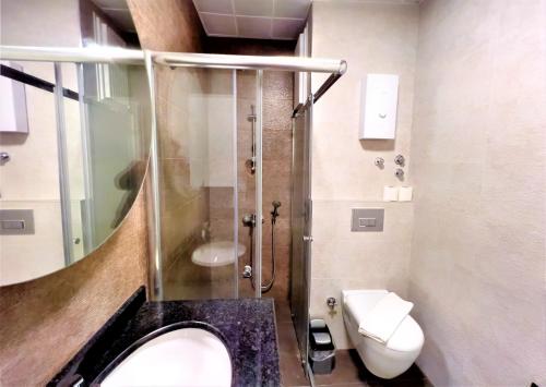 a bathroom with a shower and a sink and a toilet at Flat with Shared Pool and Backyard in Alanya in Avsallar