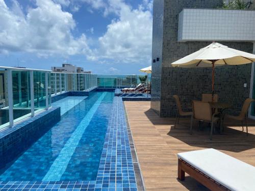 a swimming pool on the roof of a building at Promenade II PONTA VERDE in Maceió