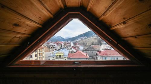 a view of a city from a window at Хотел Феникс in Chepelare