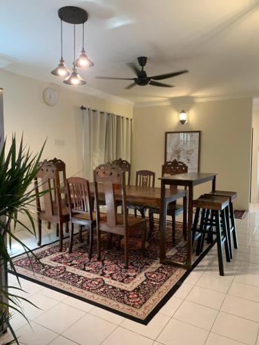 a dining room with a wooden table and chairs at D Riad Ipoh Homestay l Home Cinema l 300MBPS in Ipoh