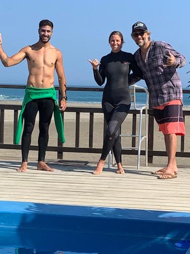 three men standing on a dock near the water at Aloha Lobitos in Lobitos