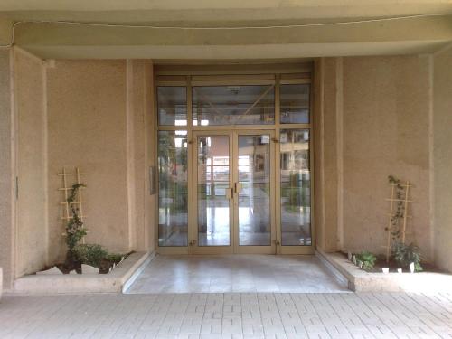 an entrance to a building with a glass door at Iridium Apartment in Skopje
