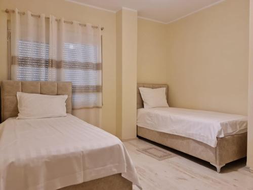 a bedroom with two beds and a window at Apartment in Qerret in Golem