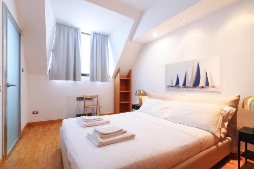 a bedroom with a bed with towels on it at Duomo Luxury Apartment VIII in Milan