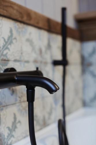 a close up of a black handle of a chair at La Maison du Marcel in Sainte-Cécile