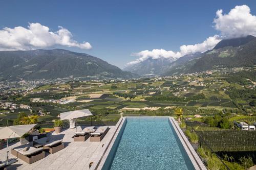 a swimming pool with a view of the mountains at Prunner Luxury Suites - Adults Only in Schenna