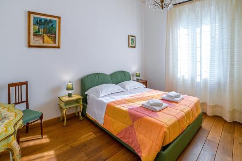 a bedroom with a bed and a chair and a window at Florence Quiet Apartment with Private Garden in Florence