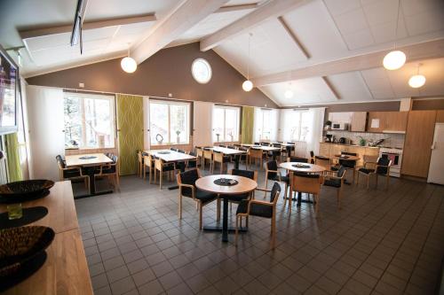 a restaurant with tables and chairs in a room at Skellefteå Camping in Skellefteå