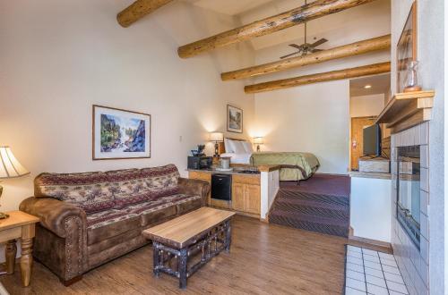 a living room with a couch and a bed at The Pines Resort & Conference Center in Bass Lake