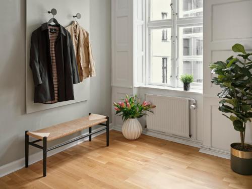 a living room with a bench and a window at Rosenborg Hotel Apartments in Copenhagen