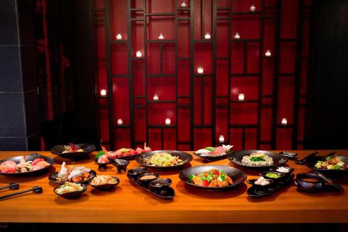 a table with many bowls of food on it at The St. Regis Bora Bora Resort in Bora Bora