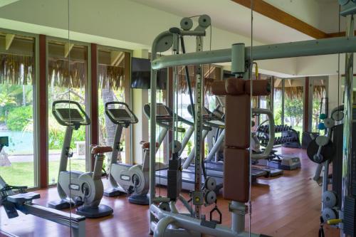 a gym with rows of treadmills and elliptical machines at The St. Regis Bora Bora Resort in Bora Bora