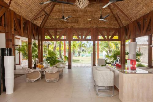 a pavilion with tables and chairs in a building at The St. Regis Bora Bora Resort in Bora Bora