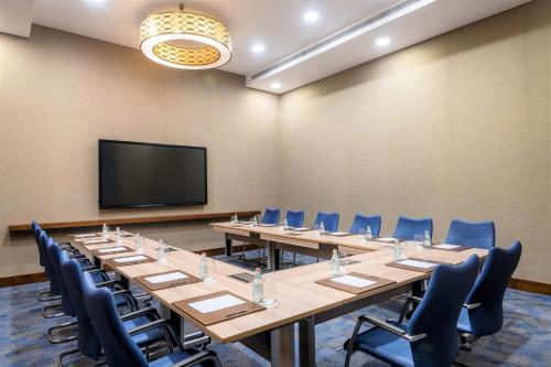 a conference room with a large table and chairs at Al Messila, A Luxury Collection Resort & Spa, Doha in Doha