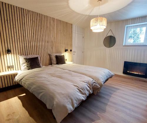En eller flere senge i et værelse på Vakantiewoning Barrage27