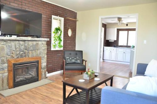 a living room with a fireplace and a couch at 3 bedroom country home pet friendly in Monroe
