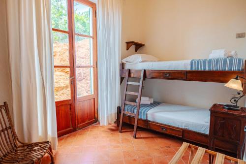 a bedroom with two bunk beds and a ladder at Tenuta Delle Ripalte in Capoliveri