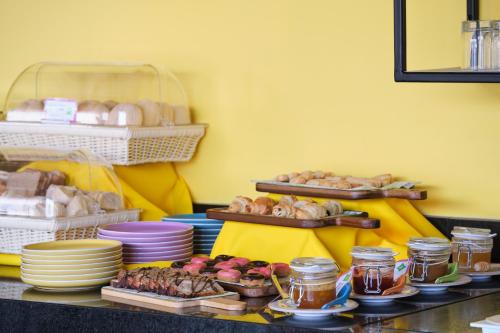 a table with plates of bread and pastries on it at ibis Styles Antofagasta in Antofagasta