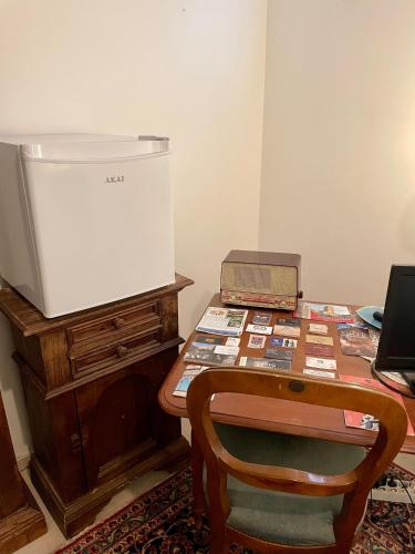 a table with a box on a desk with a chair at A casa di Asia in Viterbo