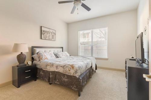 a bedroom with a bed and a ceiling fan at Home felt apartment- Med Center/NRG in Houston